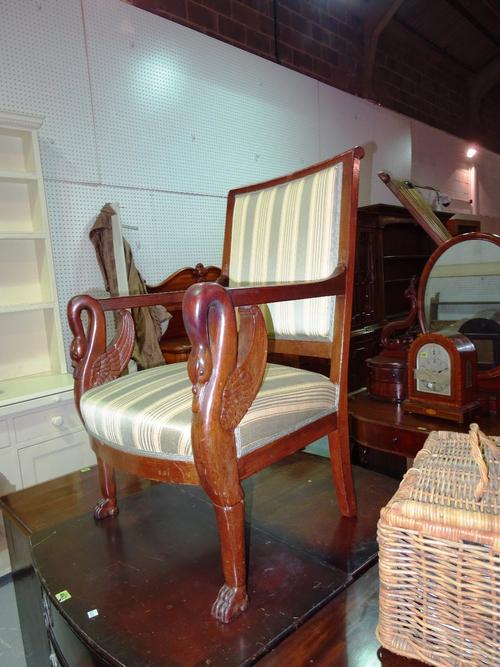 An Empire style mahogany framed open armchair with stripe upholstery and swan's head arms.   C10