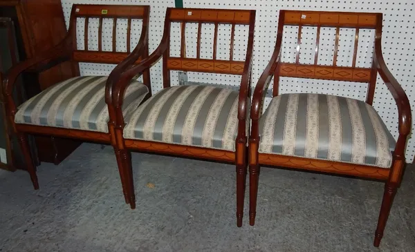 A set of three Continental mahogany and fruitwood open armchairs with stripe upholstery and turned tapering supports. (3)  M9