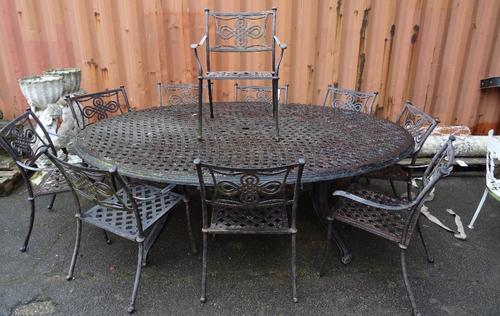 A 20th century metal oval garden table, with a set of ten matching chairs, (11).  OUT