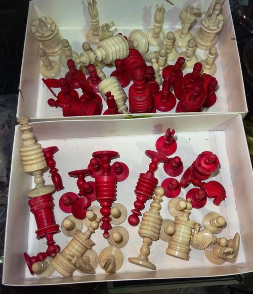 An English stained bone chess set, late 19th/early 20th century, of turned form (the king 10.5cm high) and one further similar chess set, (a.f).  CAB