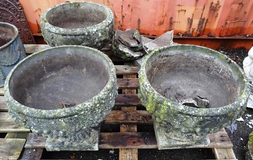 Garden Statuary, including; a group of four 20th century stone garden urns, with relief decoration of fruit, 43cm wide x 41cm high, (1 a.f) (4)   OUT