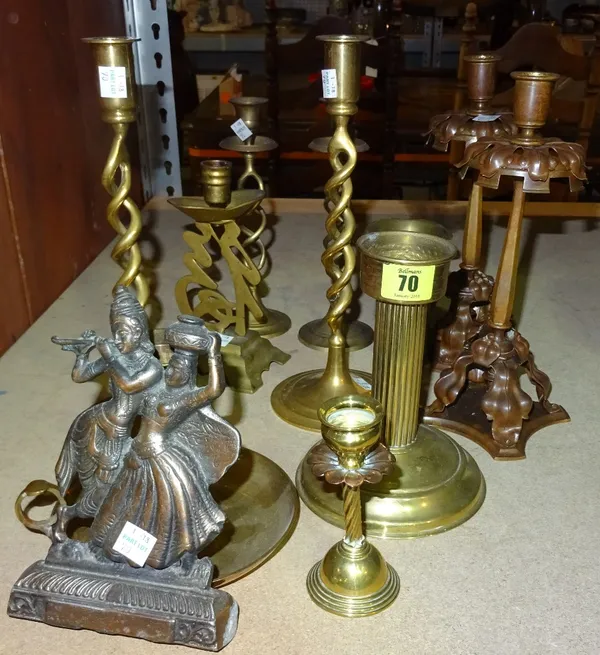 A pair of patinated bronze candlesticks, and a group of further bronze candlesticks, (qty).  S3