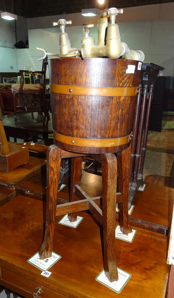 An oak cooper bound bucket on stand, 30cm wide x 72cm high and a set of brass taps, (2)  G6
