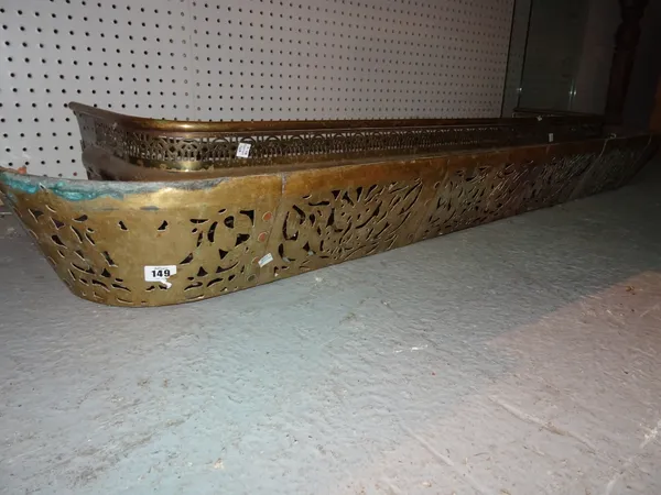 A 19th century pierced brass fire fender, 160cm wide and another 130cm wide, (2).  L8