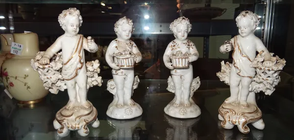 A pair of Continental porcelain white and gilt models of Putto and a similar pair, 13cm high, (4).  CAB