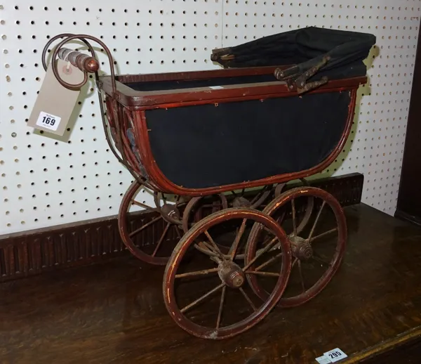 An early 20th century stained pine framed doll's carriage, 49cm wide x 51cm high.  C9