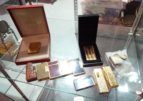 Lighters, including; gold plated St Dupont lighter, cased, a gold plated 5th Avenue lighter, cased, a gold plated Dunhill bark effect roller gas type
