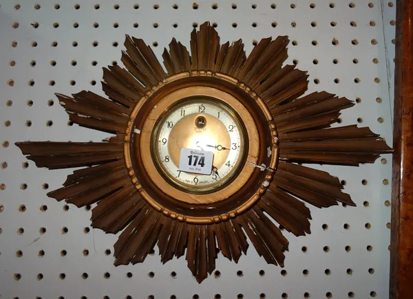 A 20th century Smiths gilt sunburst wall clock, 46cm wide, (a.f).   CAB