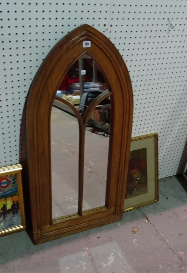 A 20th century Gothic oak framed arched wall mirror, 49cm wide x 102cm high.  F6
