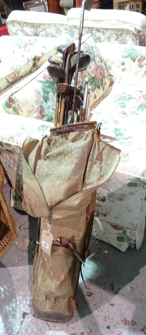 A quantity of early to mid-20th century Hickory shaft golf clubs contained in a canvas golf bag.   G2