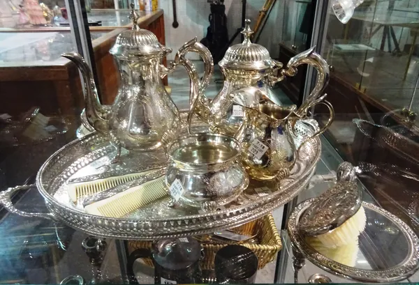 A silver plated tea and coffee set with oval tray and two silver plated brushes and a mirror, (qty).  CAB