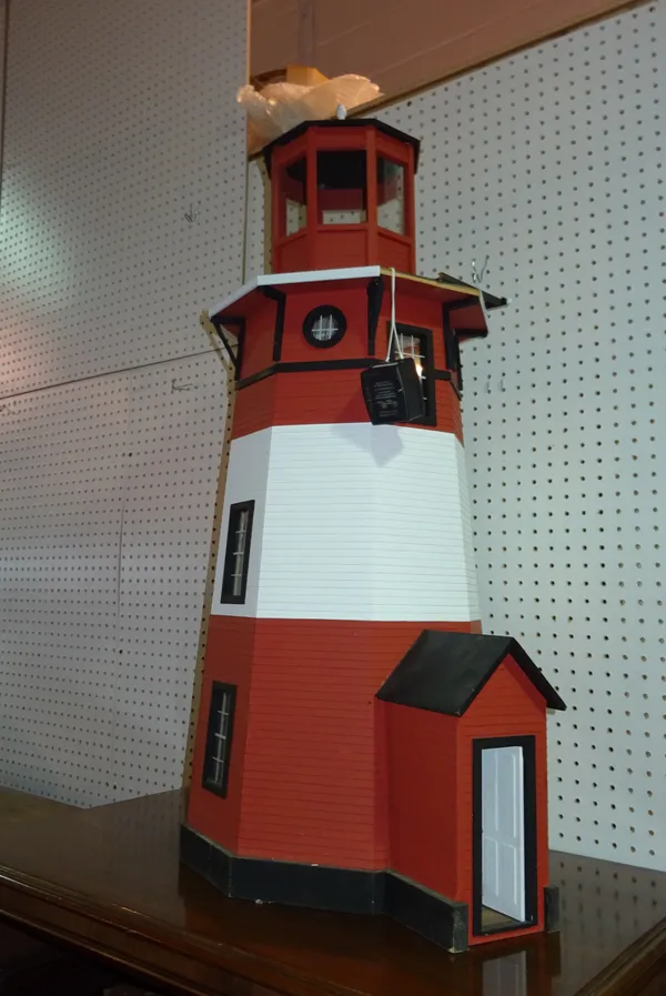 Toys, comprising; a 20th century doll's house formed as a lighthouse.  F10