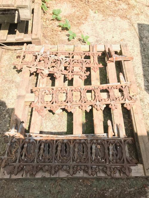 Garden statuary, comprising; a group of early 20th century cast iron garden border markers of pierced form and Prince of Wales feather finials, (qty).
