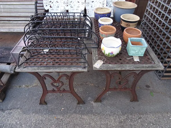 Garden furniture, comprising; a pair of 20th century wrought iron tables with dual end supports, each 118cm wide x 68cm high, (2).  OUT