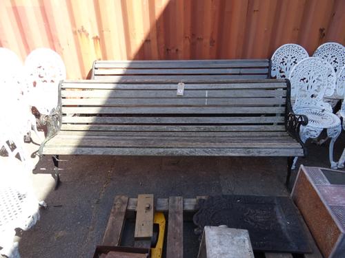 Garden furniture, comprising; a pair of 20th century teak slatted garden benches with wrought iron ends, (2).   OUT