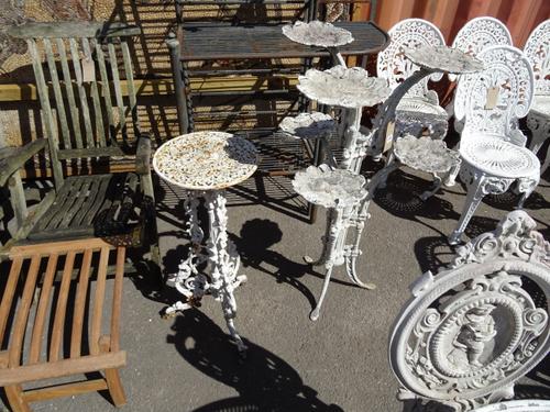 Garden furniture, comprising; a 20th century white painted metal six branch plant pot stand and a cast iron jardiniere stand, (2). OUT