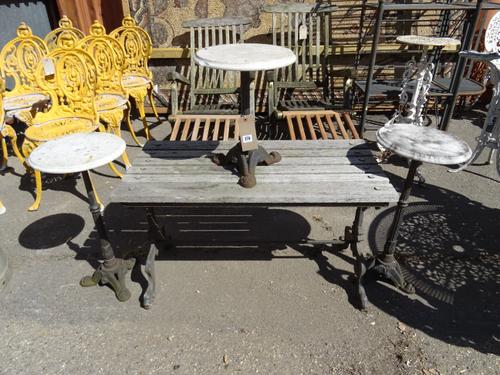 Garden furniture, comprising; a 20th century hardwood side table with cast iron legs and three cast iron tripod tables with marble tops, (4)  OUT