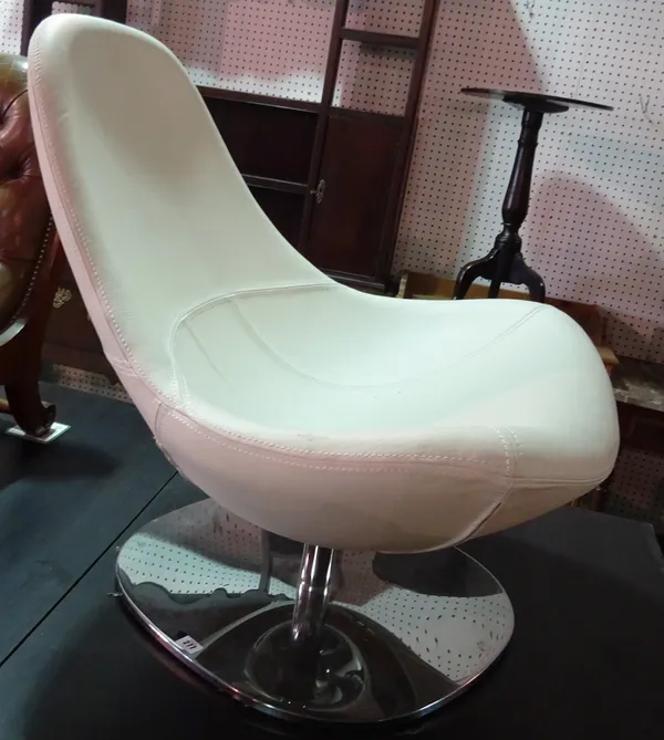 IKEA; a low white leather swivel tub chair on chrome base. E9