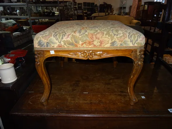 An early 20th century walnut square footstool on carved cabriole supports, 50cm wide x 38cm high.  BAY 1