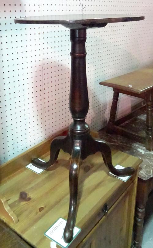 A George III mahogany tripod table with circular top on baluster column, 43cm diameter.F10