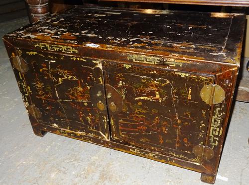A late 19th century Chinese black lacquer chinoiserie decorated two door cabinet, 89cm wide x 53cm high.  BAY 3