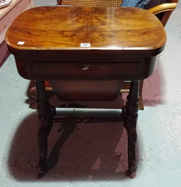 A Victorian walnut games table with single drawer and carved supports.   BAY 1