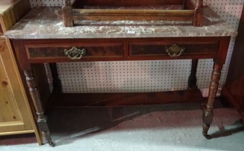 An Edwardian walnut marble top two drawer side table, formerly a wash stand, 120cm wide. F10