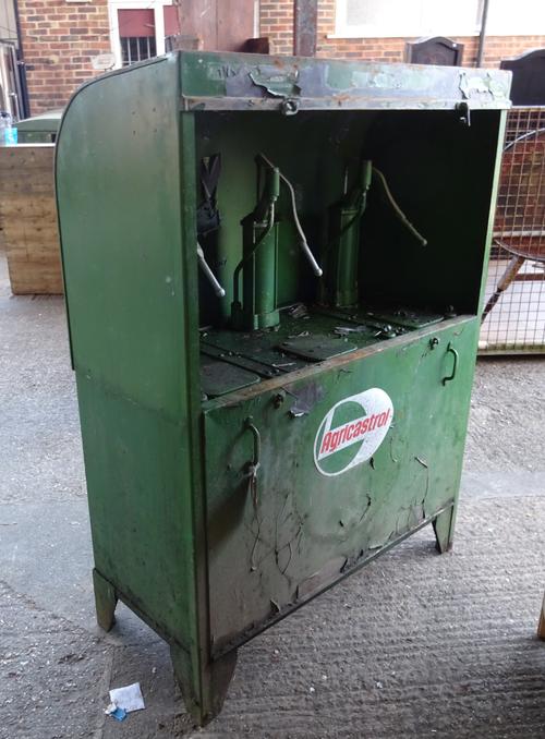 A green painted 'Agricastrol' oil station, the domed hood enclosing three old pumps over a large single reservoir, 'Agricastrol' sign to front panel,