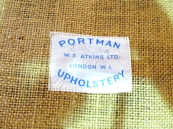 Portman Upholstery; a 20th century low armchair and matching footstool, (2).   J8