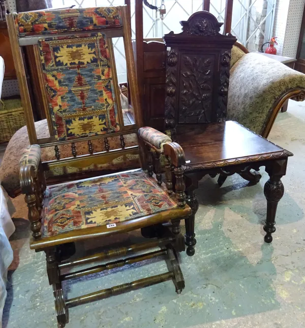 An early 20th century mahogany framed rocking open armchair and a 18th century style oak hall chair with carved back, (a.f), (2).  B5