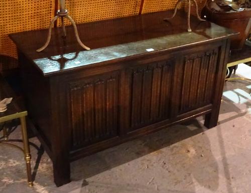 A 20th century oak coffer with triple linen fold panel front, 108cm wide x 62cm high.  BAY 1