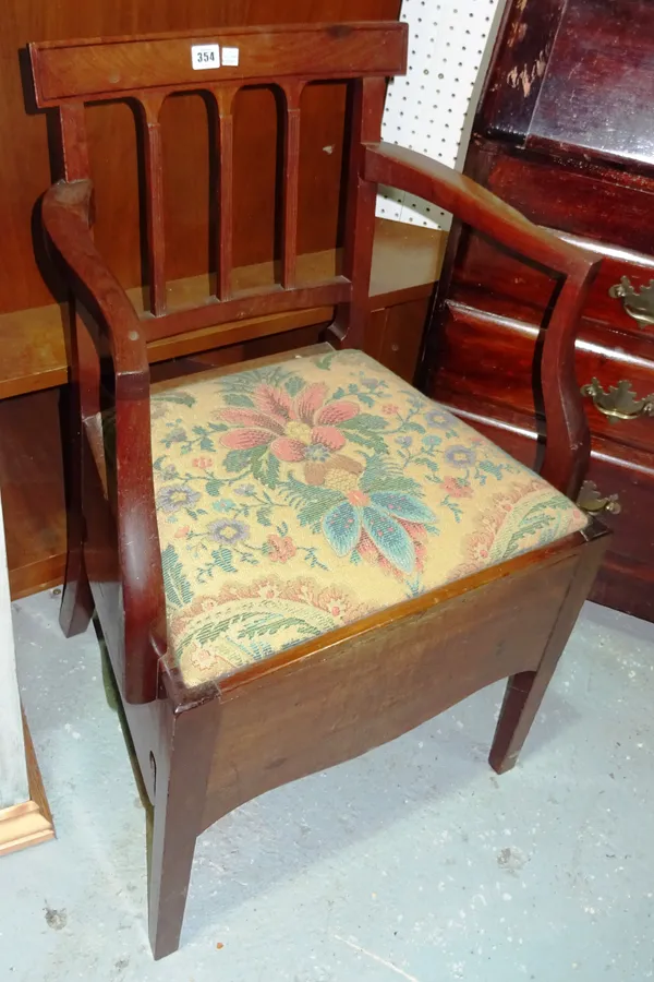 A George III mahogany commode open armchair.   A10