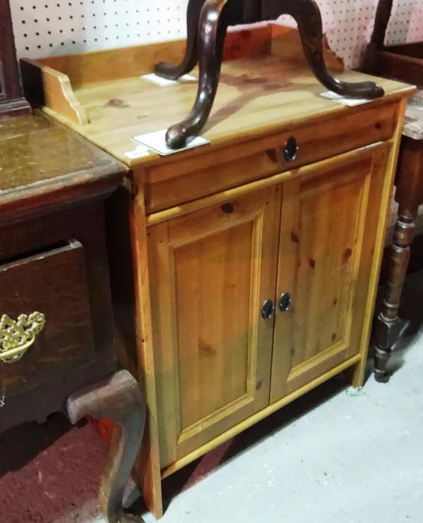 A 20th century pine side cabinet with single drawer over a pair of cupboards, 67cm wide. E10