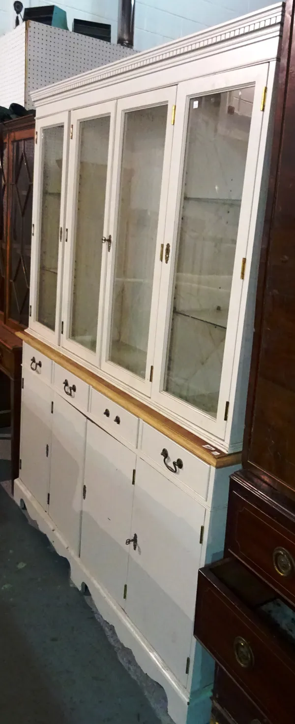 A 20th century grey painted bookcase cabinet with glazed top section over four cupboards, 124cm wide.   M8