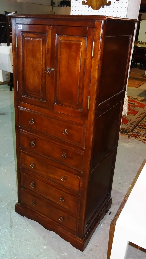 A 20th century mahogany side cupboard with panelled doors over five drawers, 61cm wide.   D5