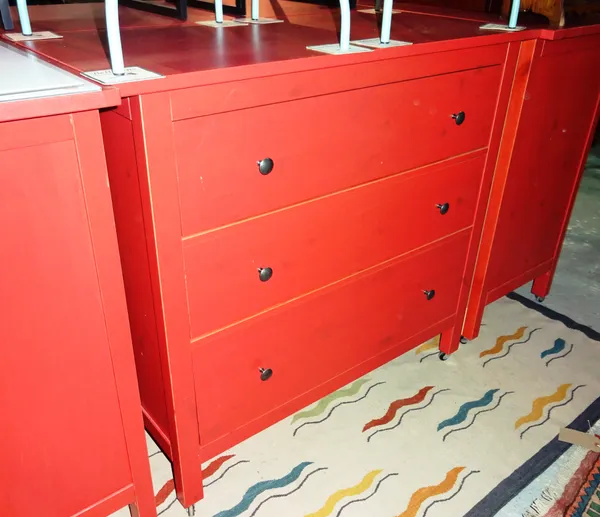 A pair of 20th century IKEA red painted chests with three drawers, 110cm wide, (2).  H8