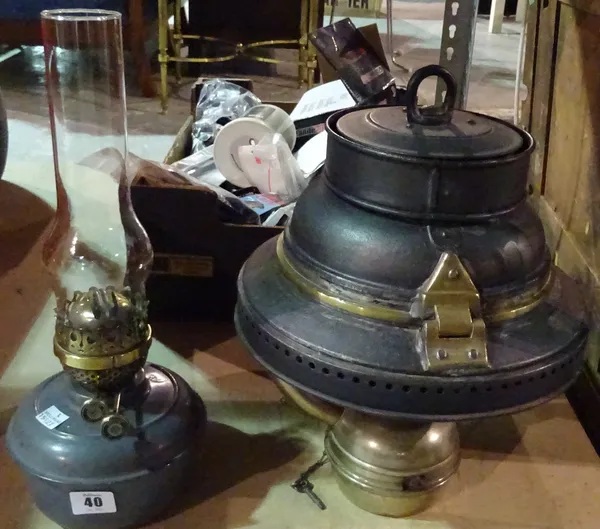 A 20th century hanging oil lamp and a military oil lamp reservoir, (2).   S2B