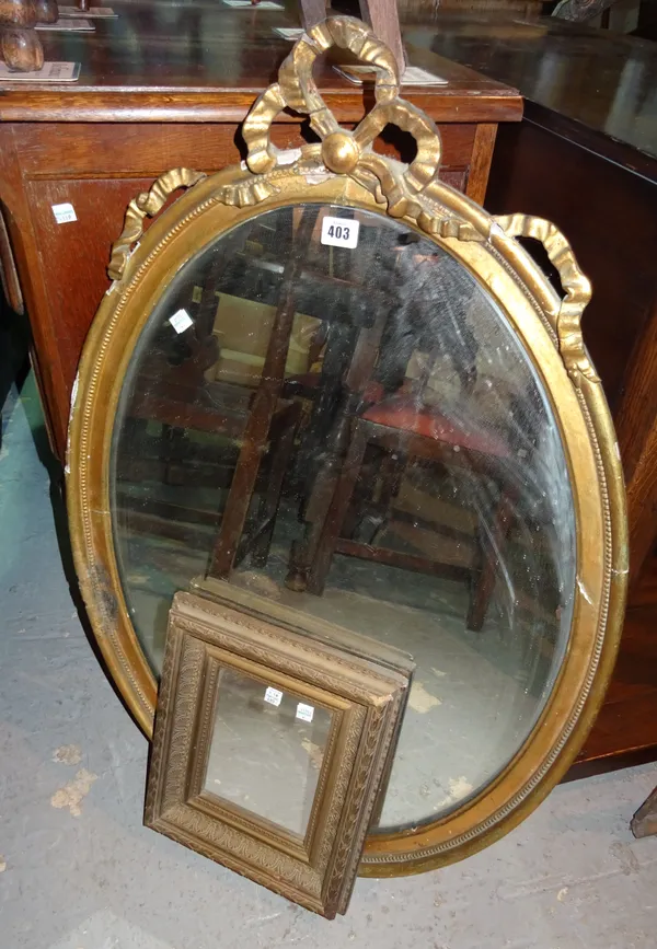 A 19th century gilt framed oval wall mirror with ribbon tied crest, 61cm wide x 90cm high and a small square framed mirror, 27cm wide, (2).   J10