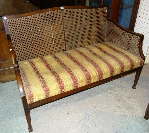 A George III style mahogany framed bergere two seat sofa on square tapering supports, 117cm wide.  G4