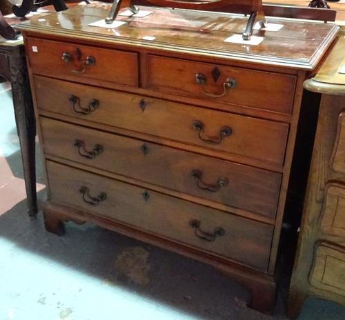 An early 19th century mahogany chest of two short and three long graduated drawers on bracket feet, 95cm wide x 89cm high.  I9