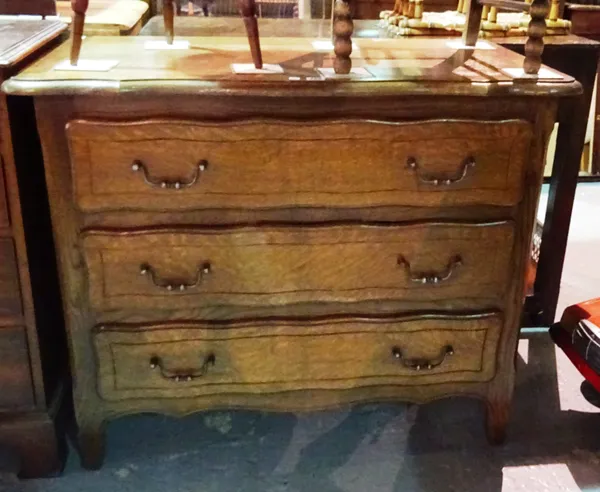 A 20th century oak serpentine chest of three long drawers, 99cm long x 82cm wide. I9