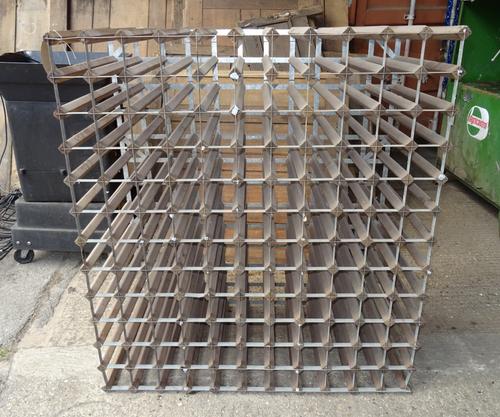 A 20th century pine and metal twelve tier wine rack, 119cm wide x 110cm high.  OUT