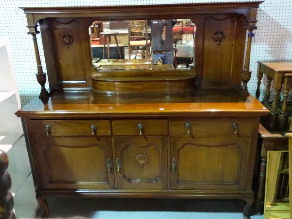 A late Victorian mahogany sideboard, with mirrored top on turned column supports, on pad feet, 181cm wide x 178cm high.  I10