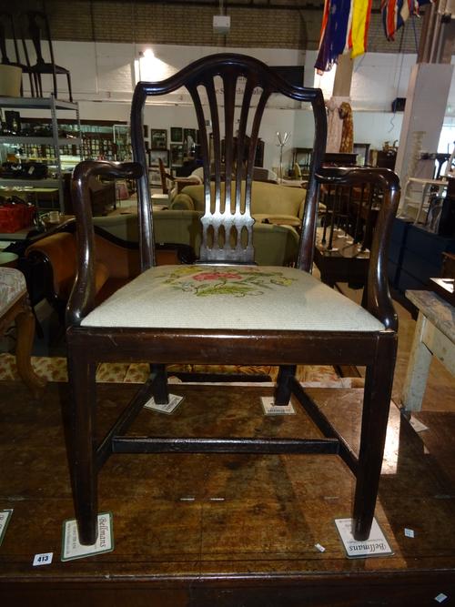 A George III mahogany shield back open armchair, on square tapering supports.  J4