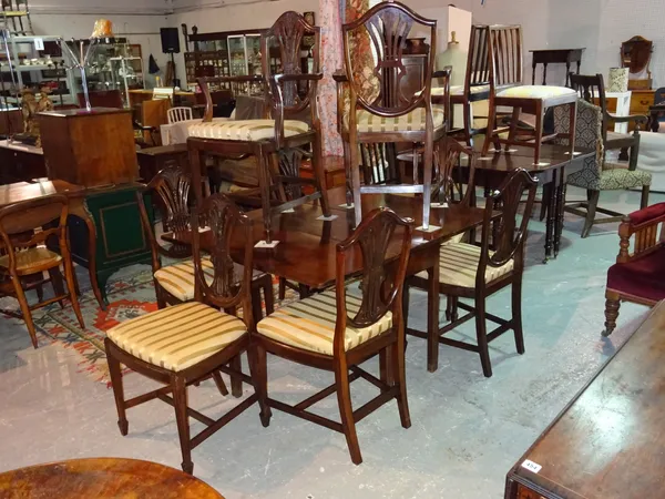 A set of eight George III style mahogany shield back dining chairs with pierced splat back, to include two carvers, (8).  F6