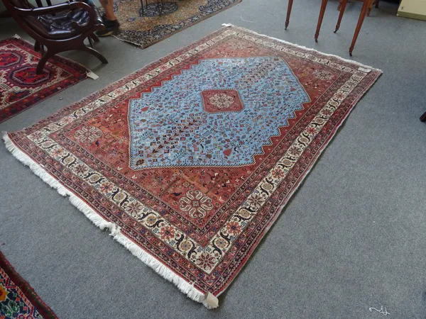 A Sarough carpet of Ghasghai design, the pale indigo field with brown diamond and spandrels, all with minor flower motifs and birds, an ivory rosette