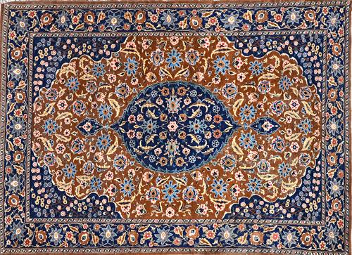 A Tabriz rug, Persian, the brown field with a dark indigo round medallion, matching spandrels, all with delicate palmette and floral sprays, a complem