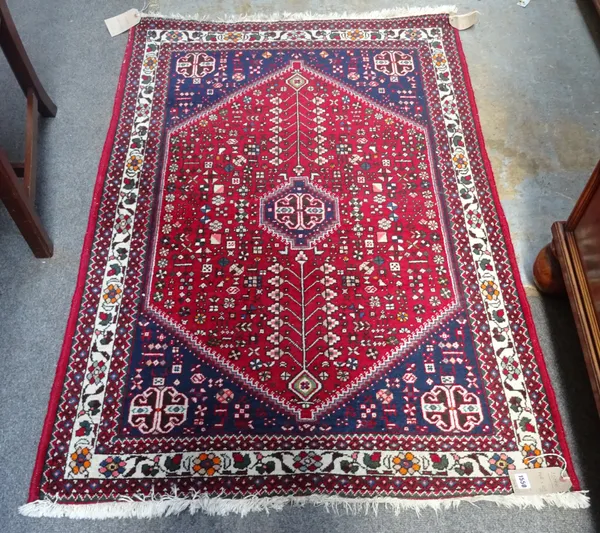 Two modern Ghasghai rugs, each with madder field, indigo spandrels, minor motifs and single ivory corner crosses, an ivory flower border, 195cm x 90cm