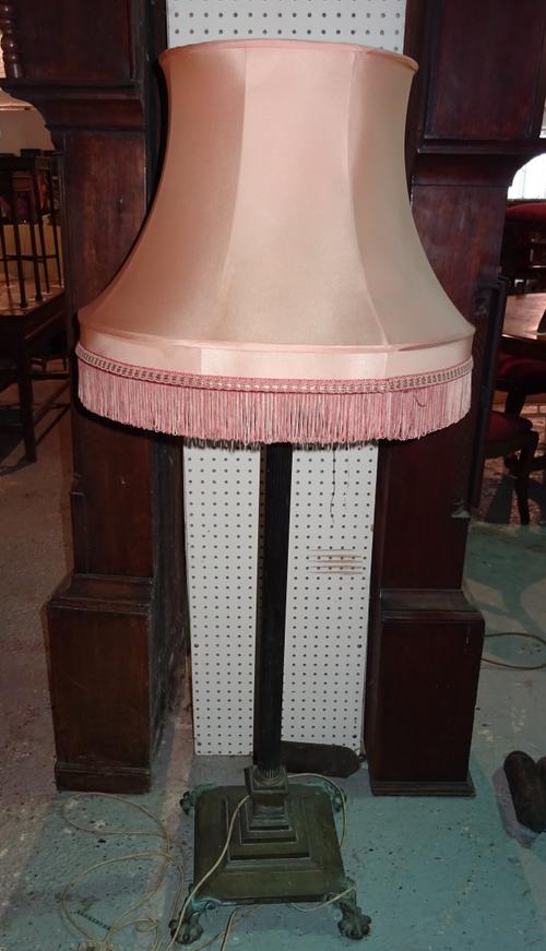 An early 20th century brass standard lamp on stepped base with claw feet, 136cm high. L3