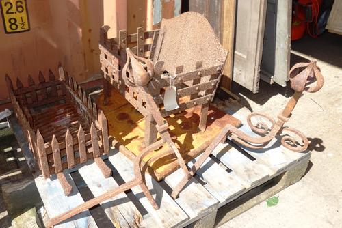 An early 20th century cast iron fire basket, 45cm wide x 48cm high, together with a cast iron fire back, 58cm wide x 69cm high, a pair of fire dogs an